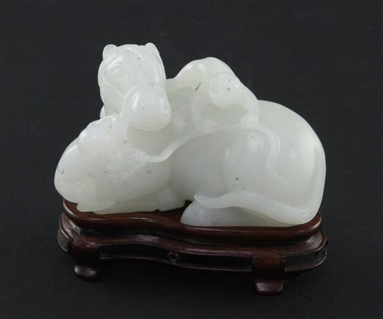 A Chinese white jade carving of two monkeys clambering on a recumbent horse, 20th century, 9cm, wood stand